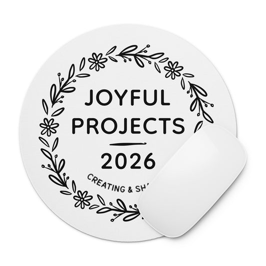 Round white mouse pad featuring a black floral wreath design with the words “Joyful Projects 2026” centered inside.