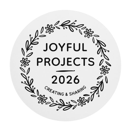 Round white mouse pad featuring a black floral wreath design with the words “Joyful Projects 2026” centered inside.