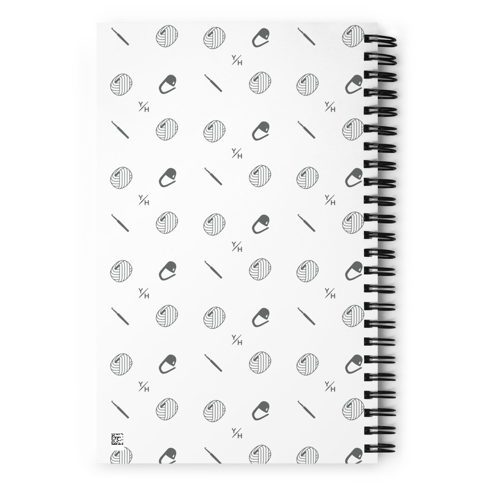 Patterned notebook back featuring Yarn Over Hook icons including yarn balls, crochet hooks, and stitch markers.