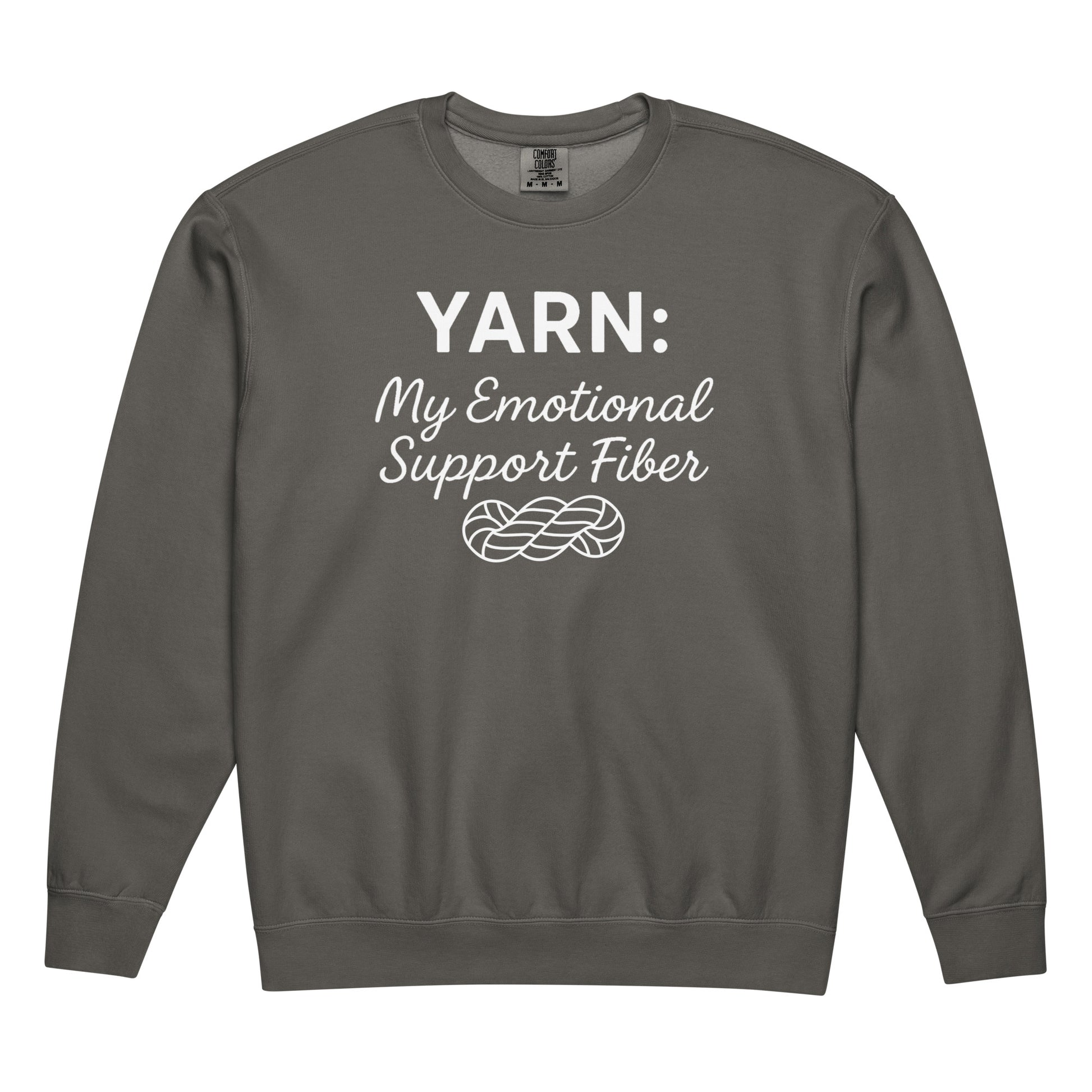 Flat-lay front view of a pepper-colored Comfort Colors crewneck sweatshirt with the white “Yarn: My Emotional Support Fiber” design and yarn skein graphic.