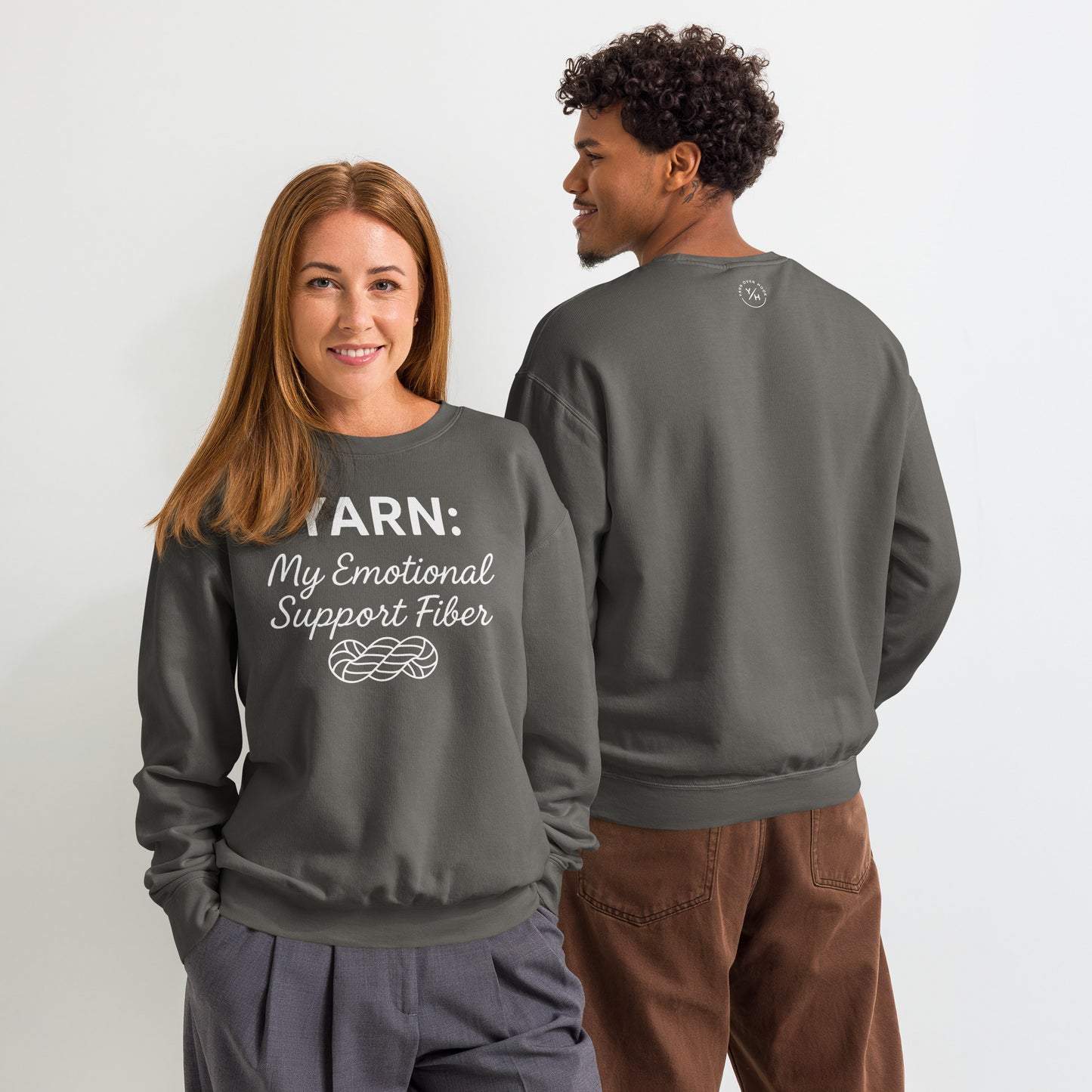Back view of a pepper-colored Comfort Colors crewneck sweatshirt featuring a small white Yarn Over Hook logo printed below the neckline.