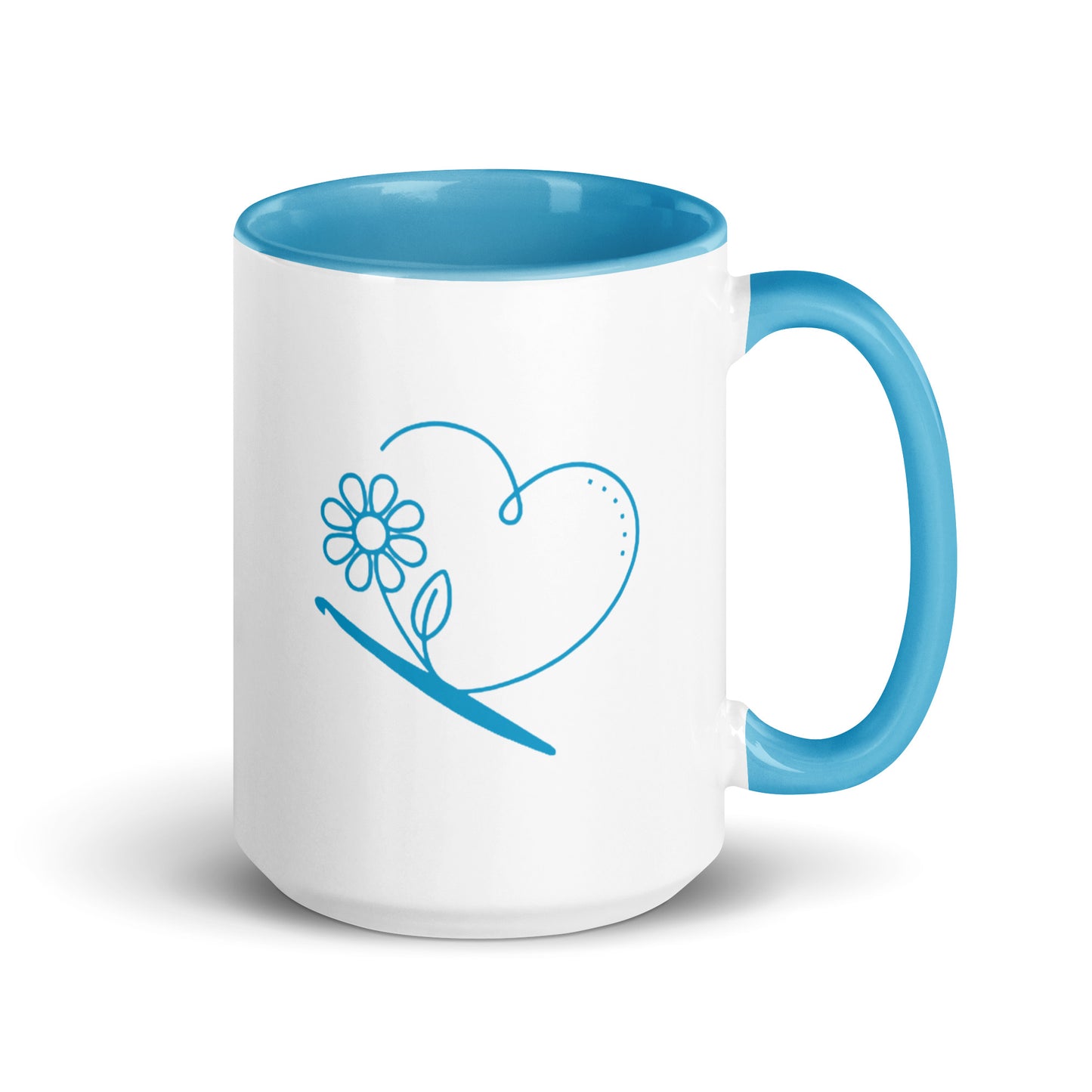 15 oz ceramic mug with blue inner color and crochet heart-and-flower illustration.