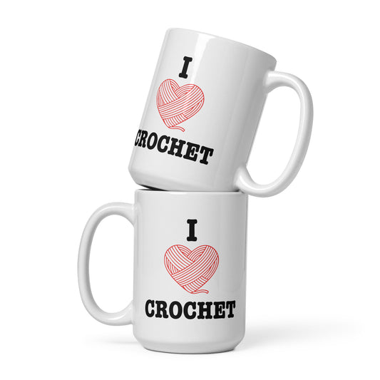 Two stacked 15oz white glossy mugs featuring the I Heart Crochet design with a red yarn-heart graphic and bold CROCHET lettering, displayed in a clean studio mockup.Product mockup